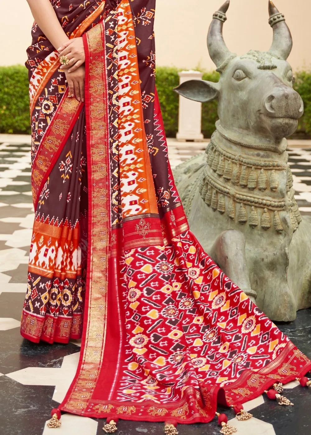 Brown & Red Patola Silk Saree with Zari Border & Tassels On Pallu